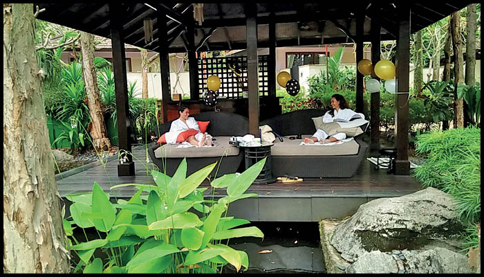 A Couple get soothing spa on the beautiful Restaurent Covered with full of Plants.